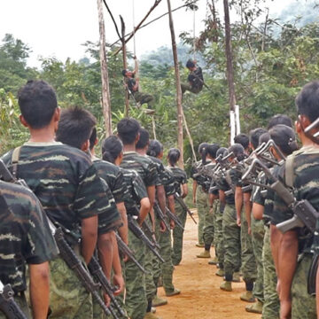 Footage of Arakan Army recruits training in 2024; cc VOA, modified, https://commons.wikimedia.org/w/index.php?search=arakan%20army&ns0=1&ns6=1&ns12=1&ns14=1&ns100=1&ns106=1#/media/File:Arakan_Army_Training.jpg