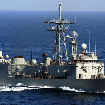 cc US Navy, modified, https://en.m.wikipedia.org/wiki/File:HMAS_Darwin_F-04.jpg / Persian Gulf (Mar. 15, 2005) — The Royal Australian Navy frigate HMAS Darwin (FFG 04) underway in the waters of the Persian Gulf alongside the Nimitz-class aircraft carrier USS Harry S. Truman (CVN 75). Darwin is a long-range escort with roles including area air defense, anti-submarine warfare, surveillance, reconnaissance and interdiction. She can counter simultaneous threats from the air, surface and sub-surface. The Truman Carrier Strike Group is on a regularly scheduled deployment in support of the Global War on Terrorism.