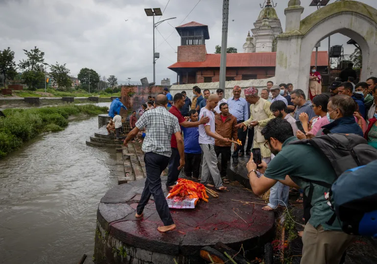Darshan Bhattarai utför en begravningsritual under kremeringsceremonin för sin far, Pushpa Raj Bhattarai, 46, som dödades i översvämningarna och ett lerskred, med hjälp av en bild istället för sin fars kropp i Pashupatinath-templet i Kathmandu, Nepal, den 3 september 2026